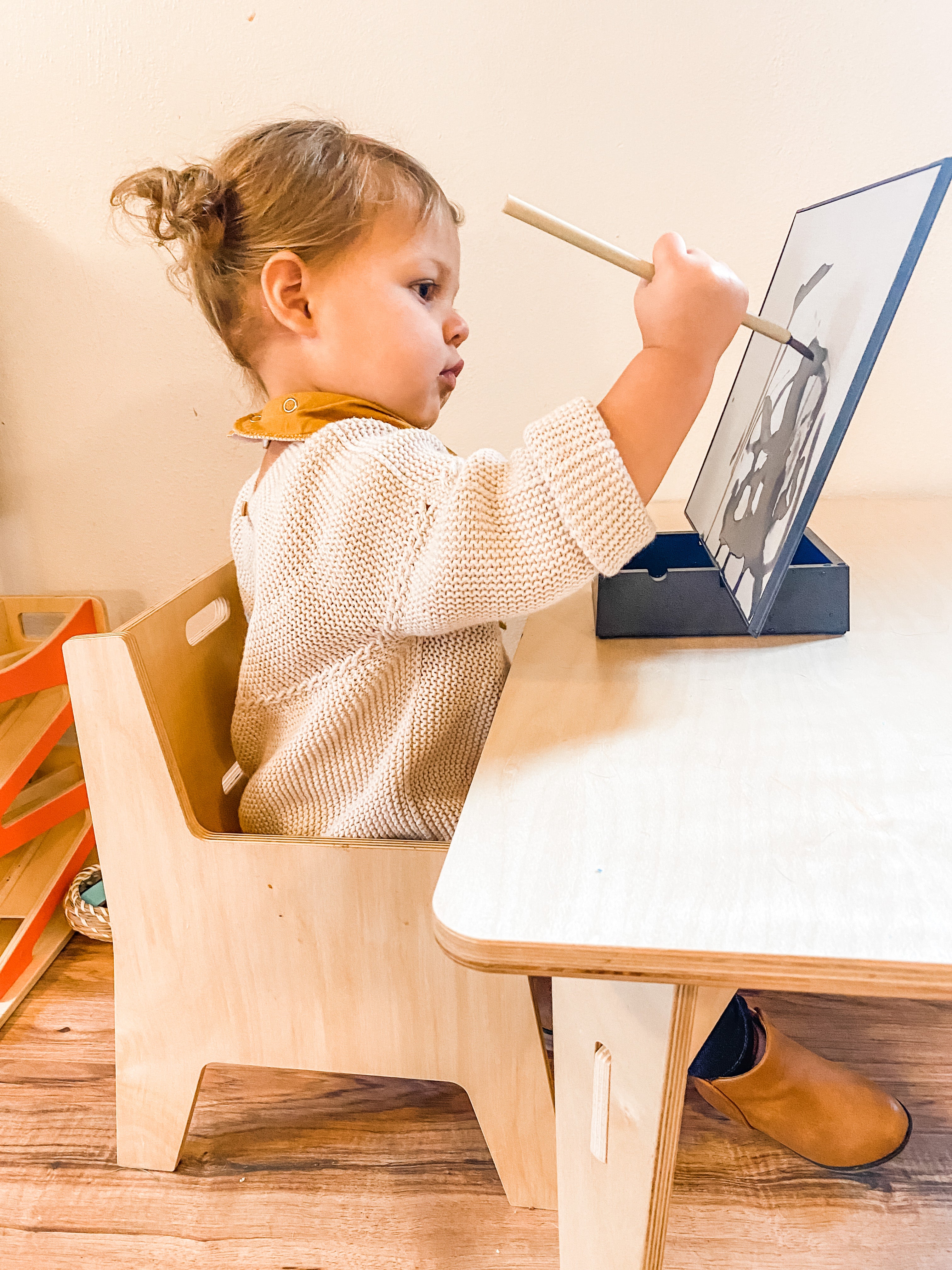 child painting montessori table